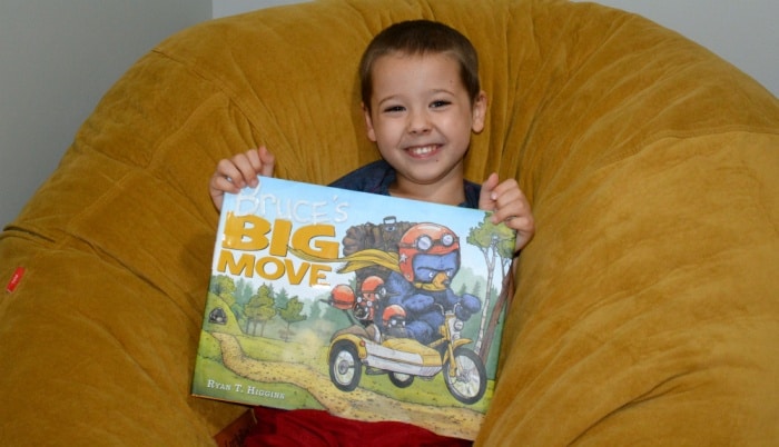 four year old holding the book Bruce's Big Move