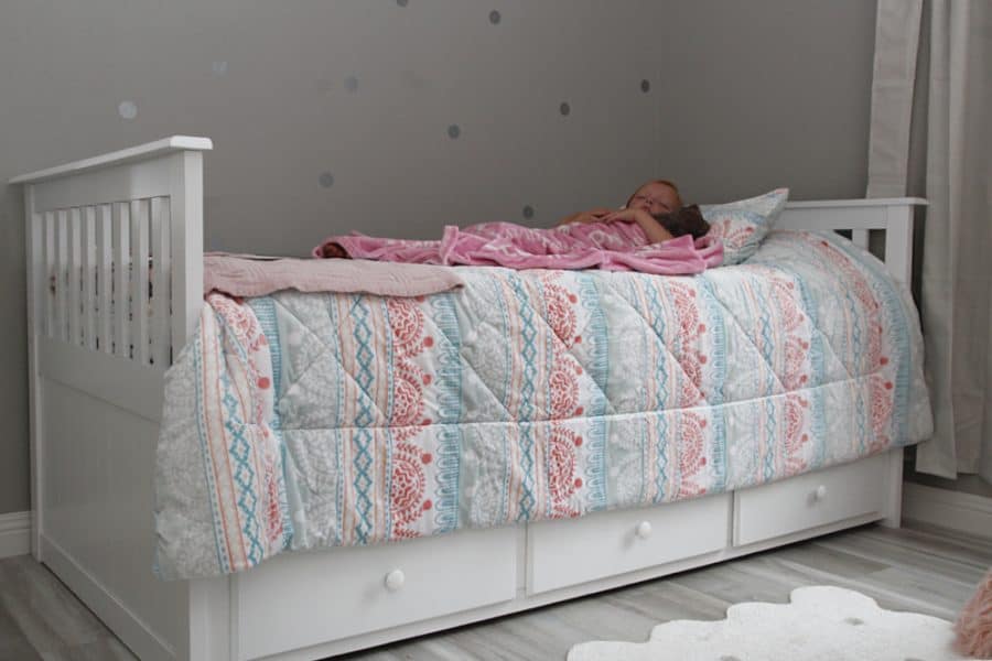 girl sleeping in bed - Benefits Of Sleep For Kids + Storkcraft Marco Island Trundle Captain’s Bed Review