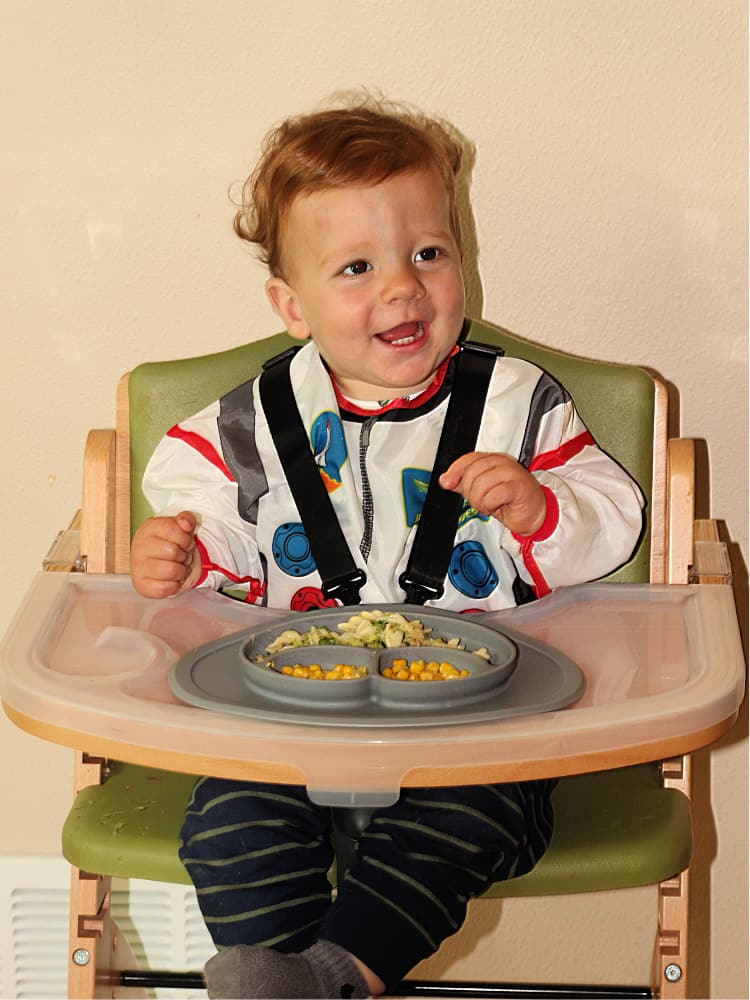 toddler eating in high chair