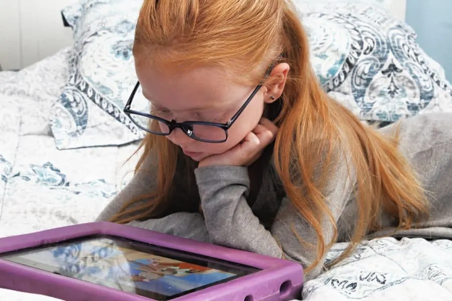 girl on iPad - Do Blue Light Glasses Really Work - What You Need To Know -- JINS Eyewear