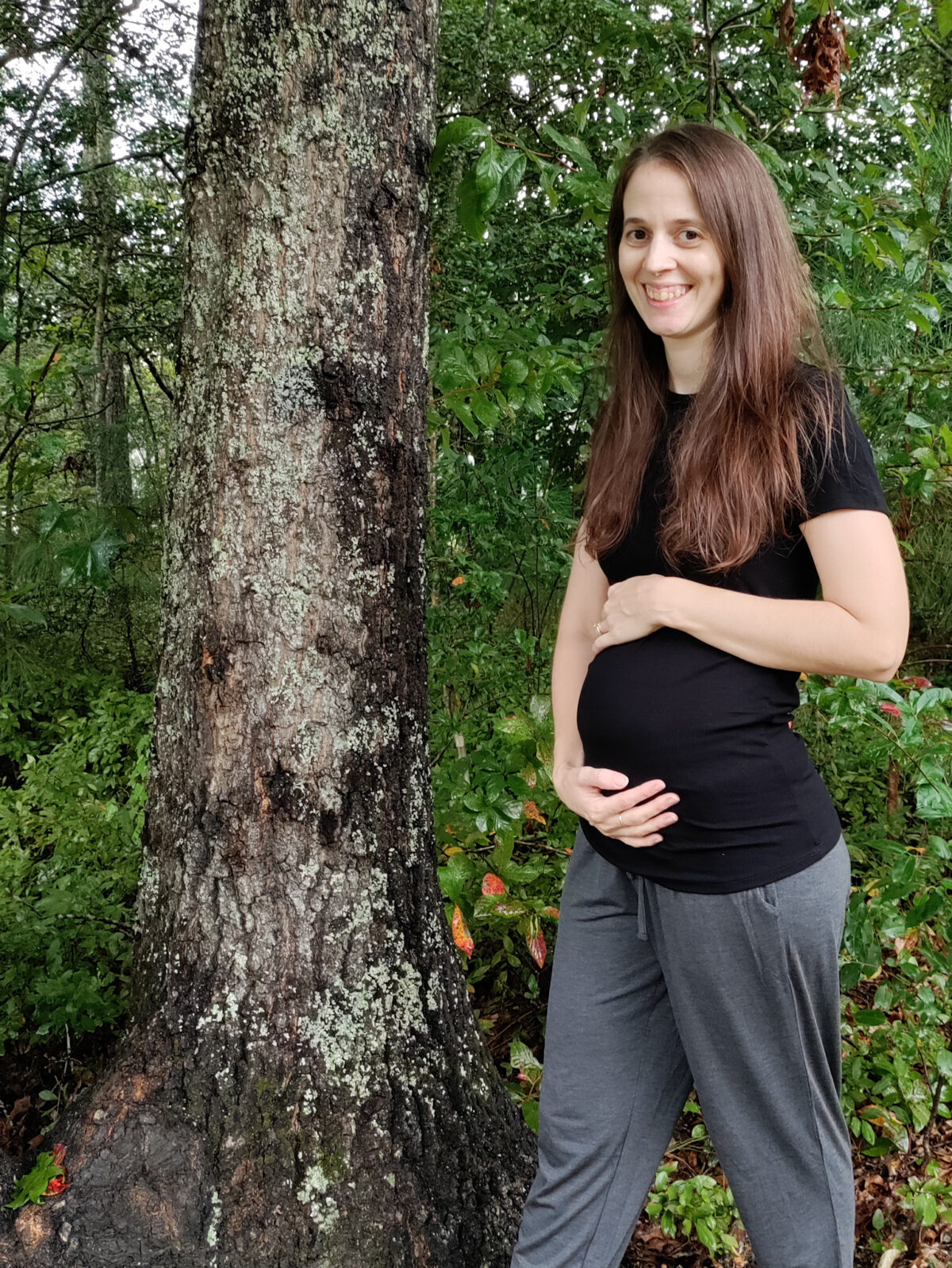 Pregnant woman by tree