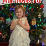 Preschool girl in front of a Christmas tree