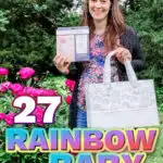 A mom holding rainbow-themed baby items with a text overlay that says:27 Rainbow Baby Must-Haves