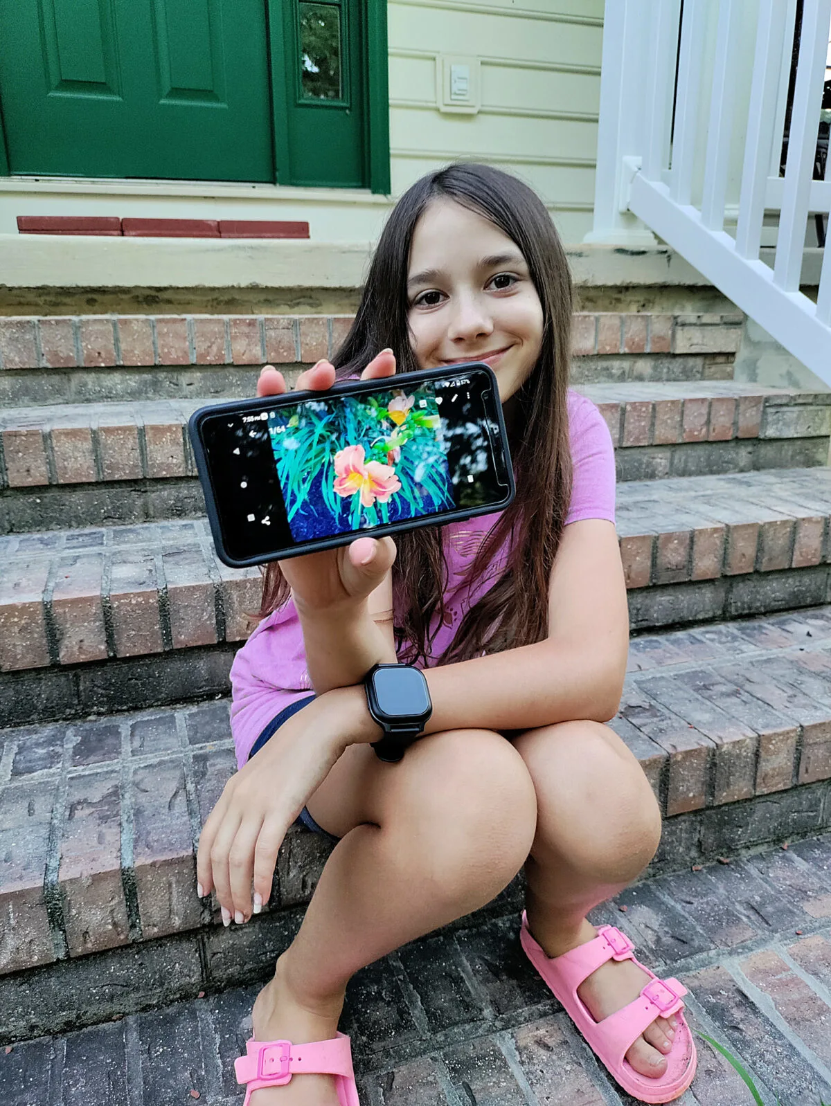 girl using a Gabb z2 phone to show a photo she took with the phone