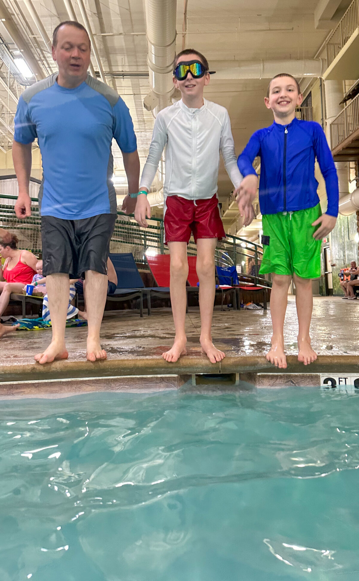 dad and boys by pool - NoNetz Swim Trunks Review. 
