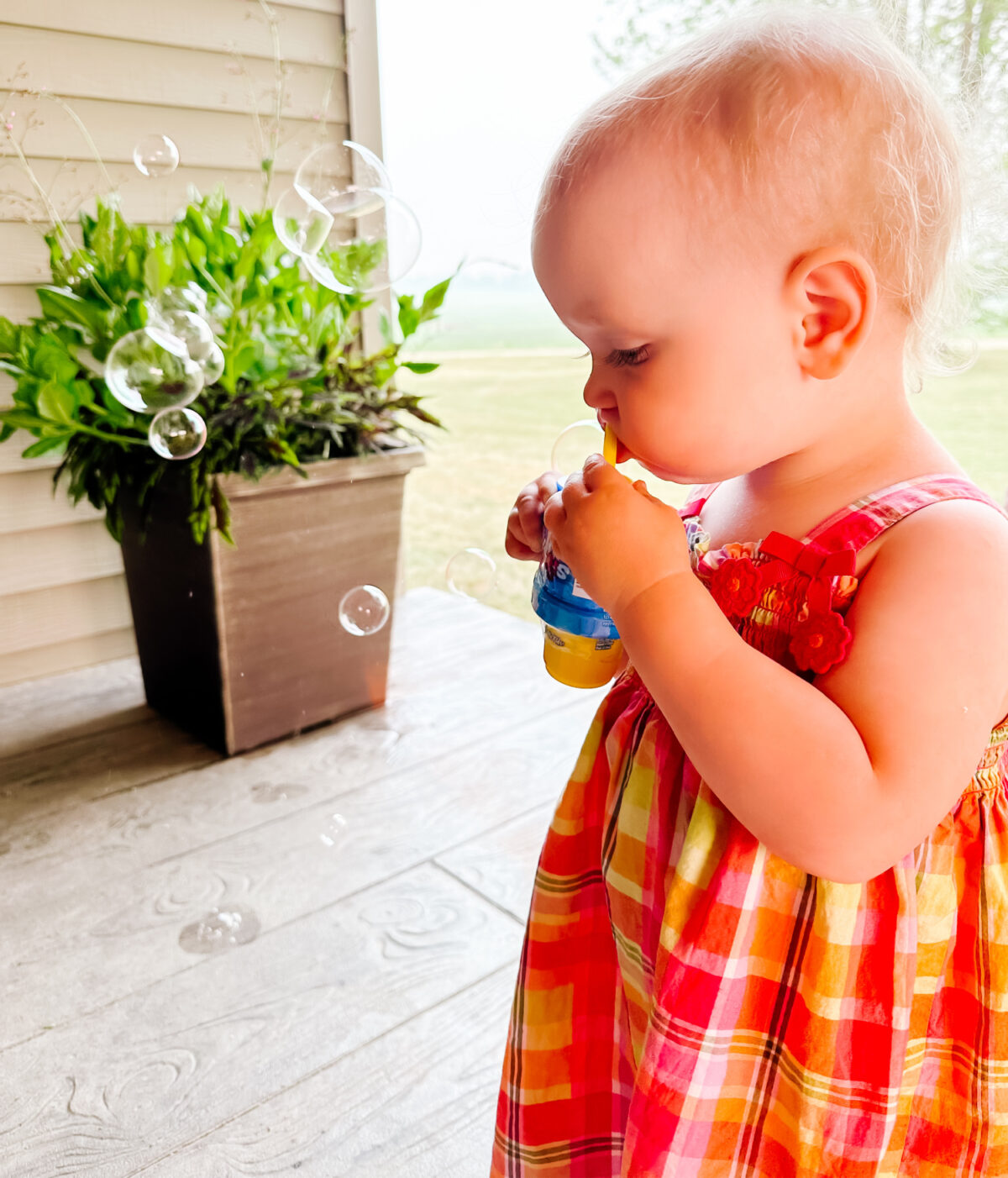 girl blowing bubbles - The Best Bubbles Toys: Fubbles Review + Giveaway