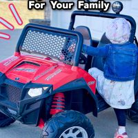 Little girl climbing on truck. Learn how to choose the right battery operated vehicle for your family. Peg Perego Polaris RZR 900 12V Ride-On Review.